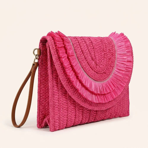 Pink boho fringe bag clutch, three-quarter angle showing side depth
