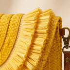 Close-up of fringe stitching and texture on Yellow boho fringe bag clutch