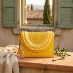 Yellow boho fringe bag clutch styled in a warm Mediterranean setting