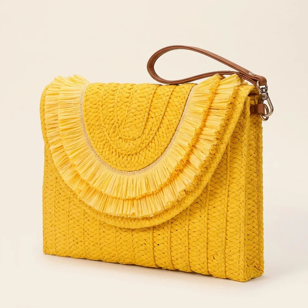 Yellow boho fringe bag clutch, three-quarter angle showing side depth