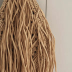 Close-up of fringe stitching and texture on Tan boho fringe hobo bag
