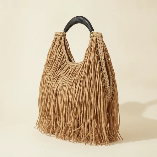 Tan boho fringe hobo bag, three-quarter angle showing side depth