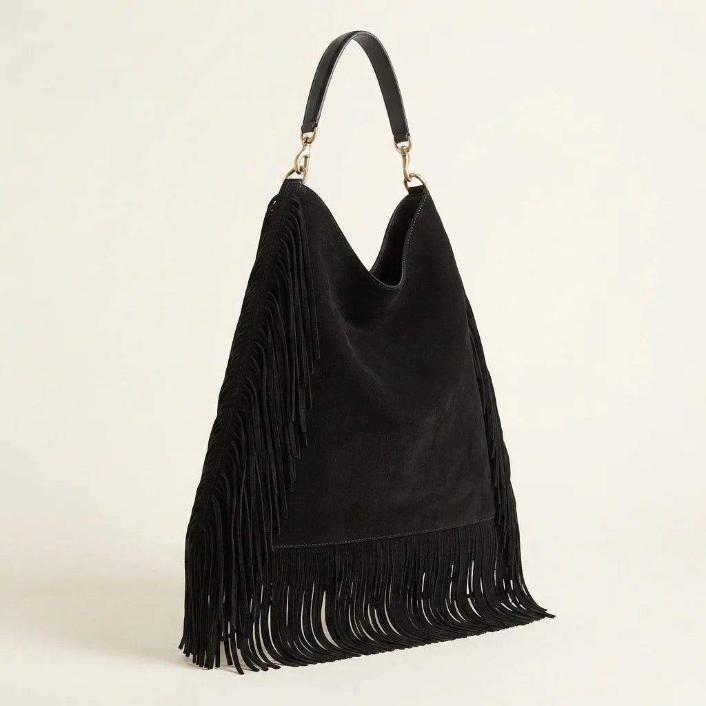 Black boho leather fringe bag, three-quarter angle showing side depth