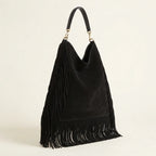 Black boho leather fringe bag, three-quarter angle showing side depth
