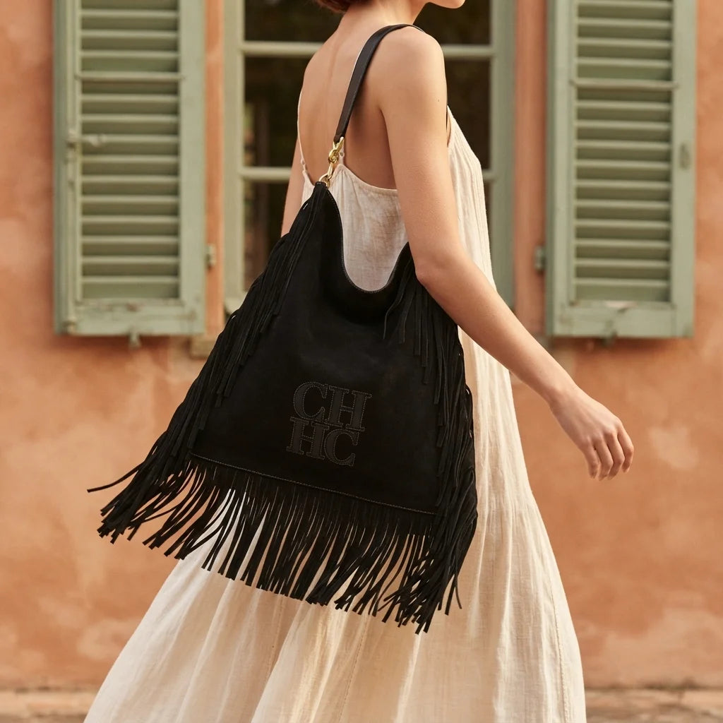 Woman wearing Black boho leather fringe bag with swaying fringe