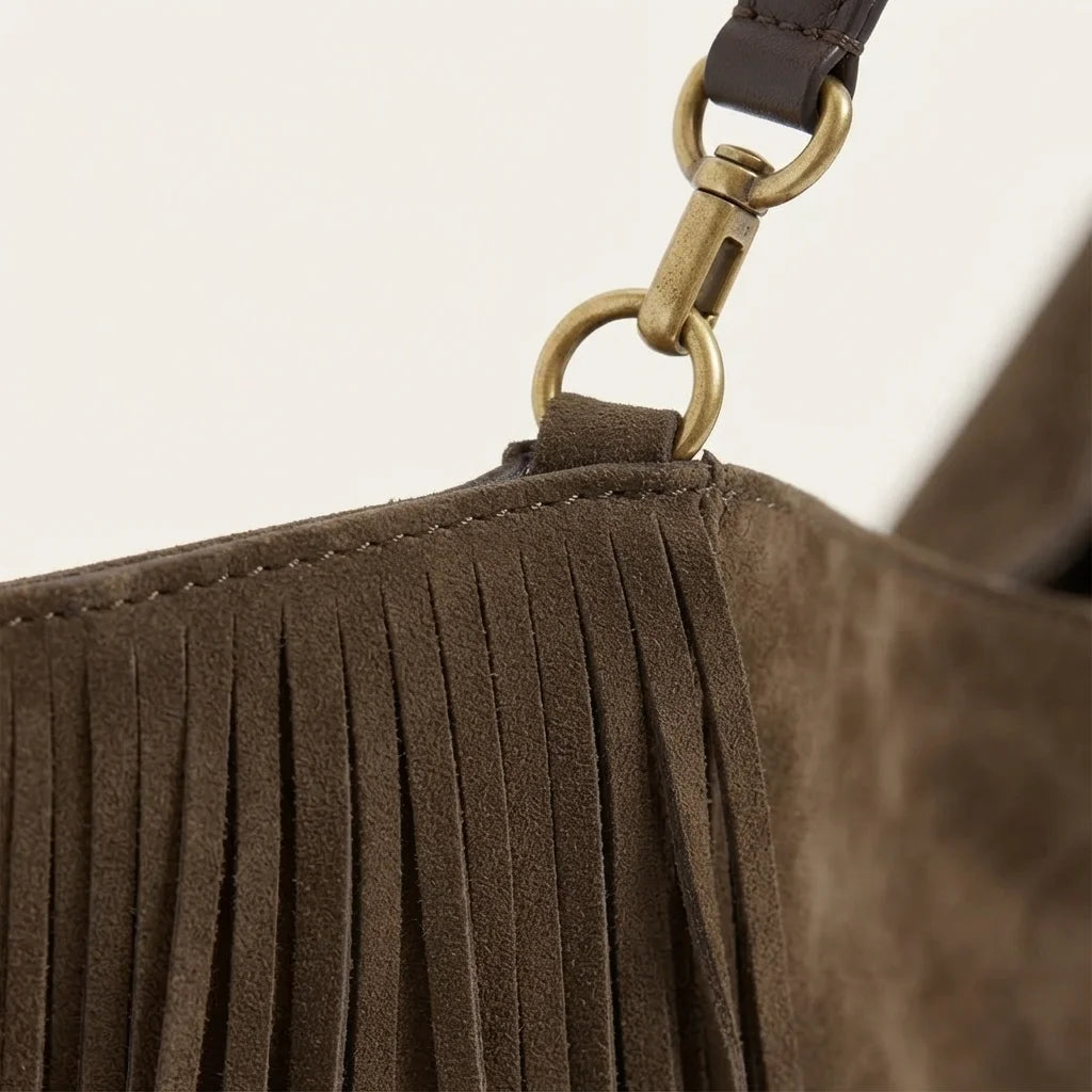 Close-up of fringe stitching and texture on Coffee boho leather fringe bag