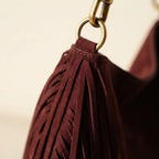 Close-up of fringe stitching and texture on Maroon boho leather fringe bag