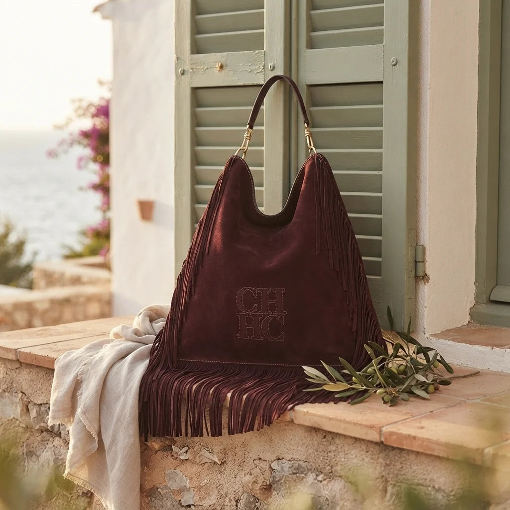 Maroon boho leather fringe bag styled in a warm Mediterranean setting