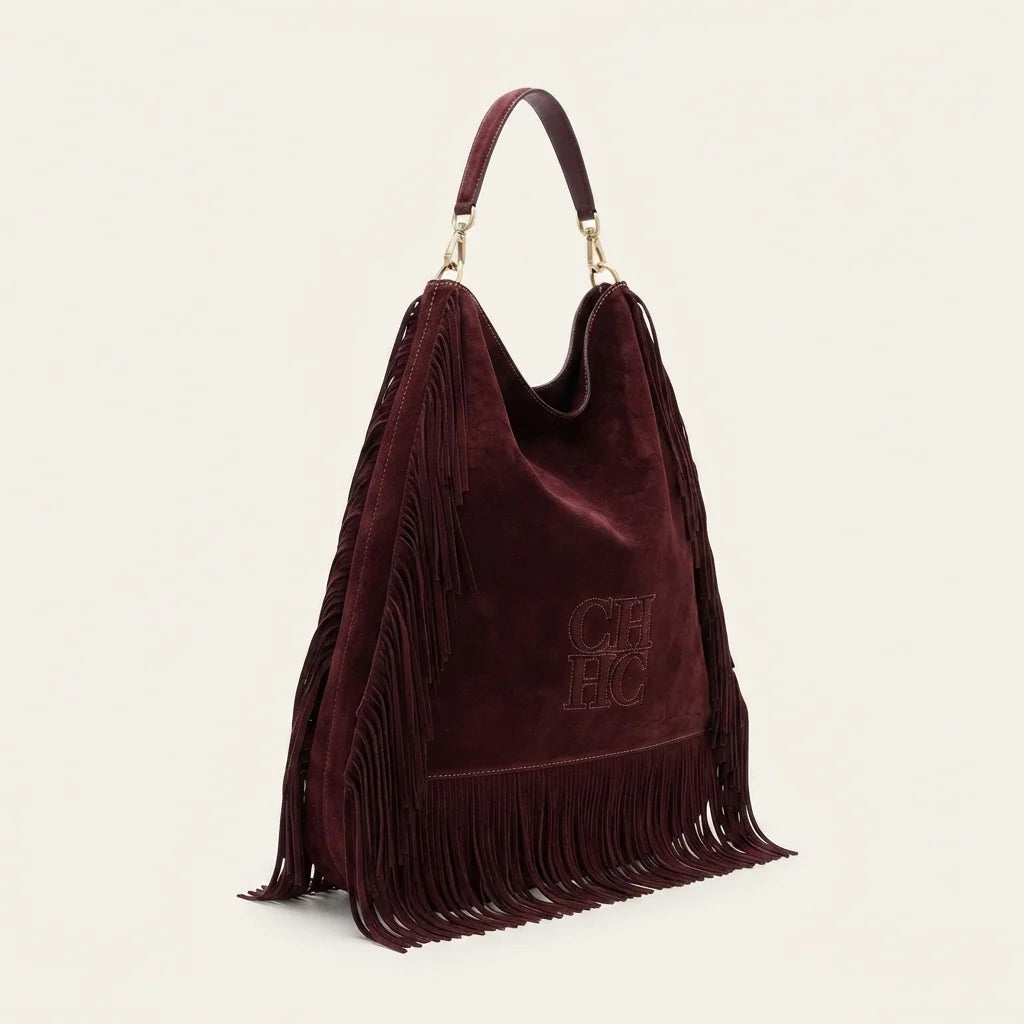 Maroon boho leather fringe bag, three-quarter angle showing side depth