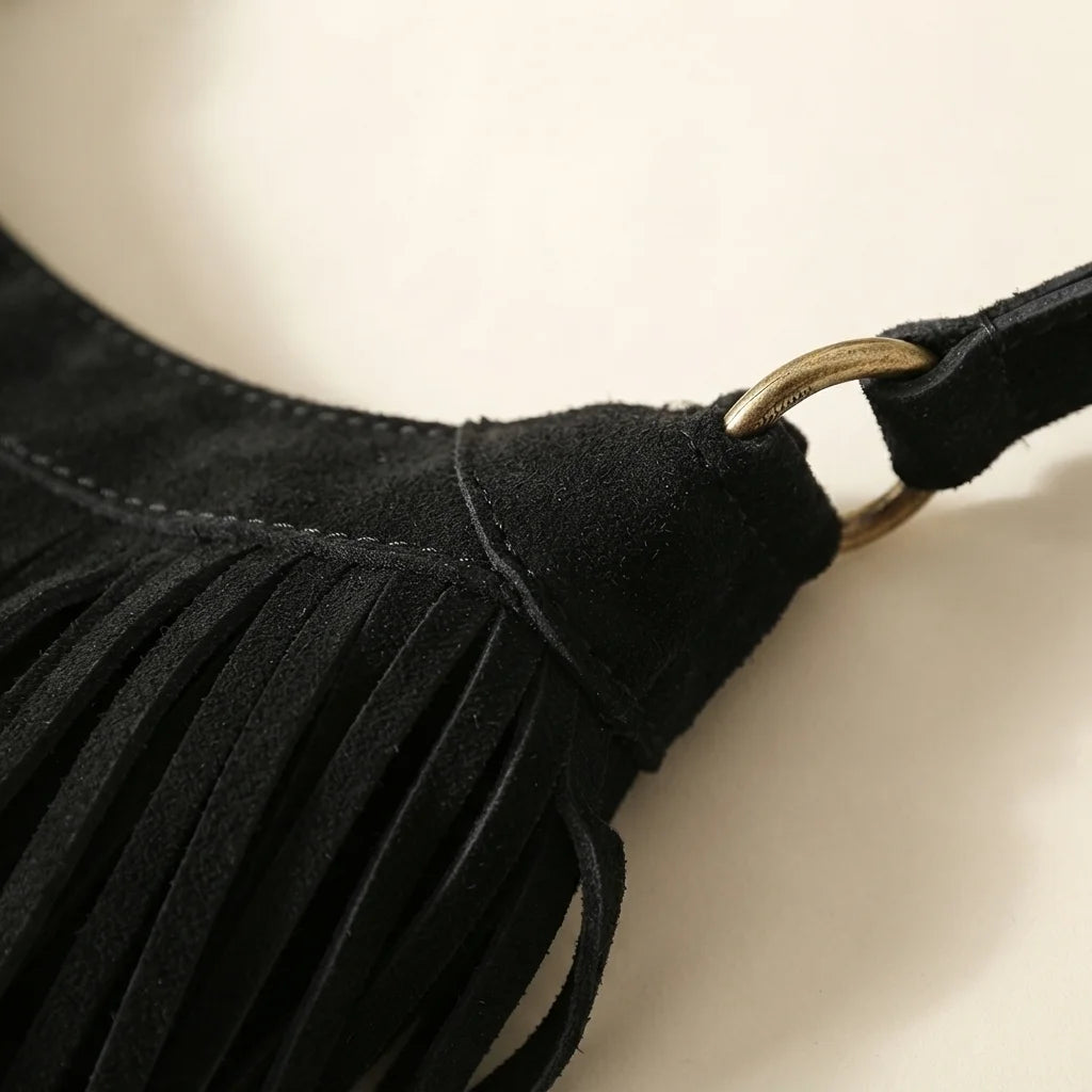 Close-up of fringe stitching and texture on Black boho style fringe bag