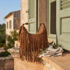 Dark Brown boho style fringe bag styled in a warm Mediterranean setting