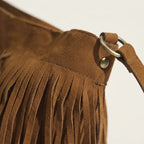 Close-up of fringe stitching and texture on Brown brown fringe bucket bag