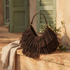 Coffee brown fringe hobo bag styled in a warm Mediterranean setting