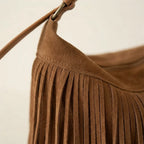 Close-up of fringe stitching and texture on Brown brown fringe suede bag
