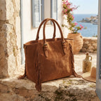 Brown brown fringe tote bag styled in a warm Mediterranean setting