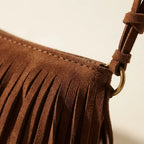 Close-up of fringe stitching and texture on Brown brown fringed sling bag