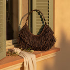 Brown brown leather hobo fringe bag styled in a warm Mediterranean setting