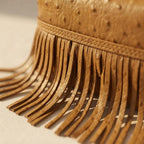 Close-up of fringe stitching and texture on Golden Brown brown leather shoulder bag with fringe