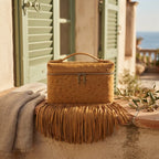Golden Brown brown leather shoulder bag with fringe styled in a warm Mediterranean setting