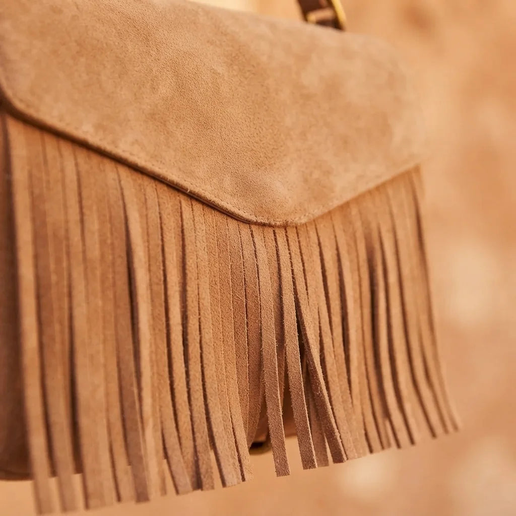 Close-up of fringe stitching and texture on Light Brown brown satchel bag with fringe