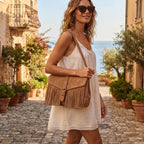Woman wearing Light Brown brown satchel bag with fringe with swaying fringe