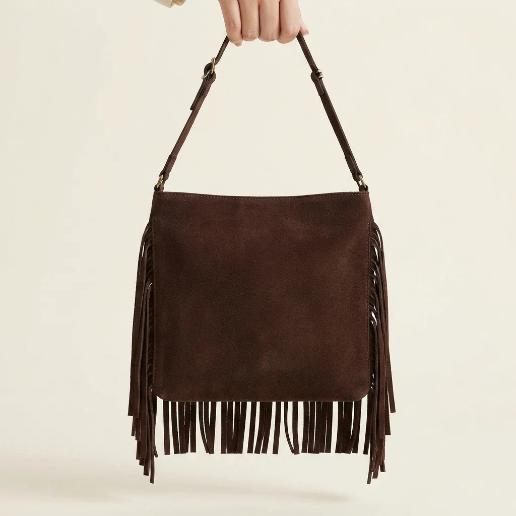 Back panel of Brown brown suede fringe crossbody bag with strap attachments