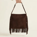 Back panel of Brown brown suede fringe crossbody bag with strap attachments