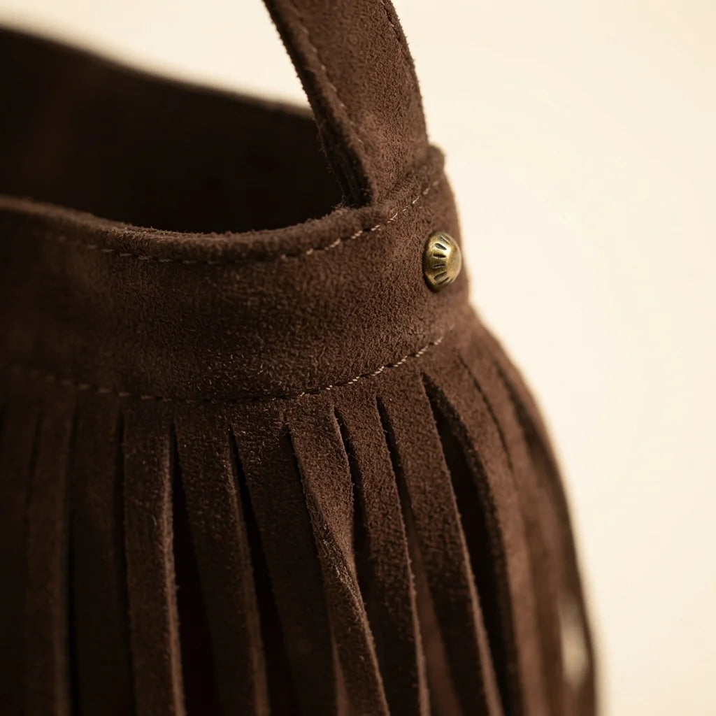 Close-up of fringe stitching and texture on Brown brown suede fringe crossbody bag