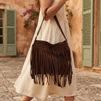 Woman wearing Brown brown suede fringe crossbody bag with swaying fringe