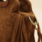 Close-up of fringe stitching and texture on Brown brown suede fringe shoulder bag