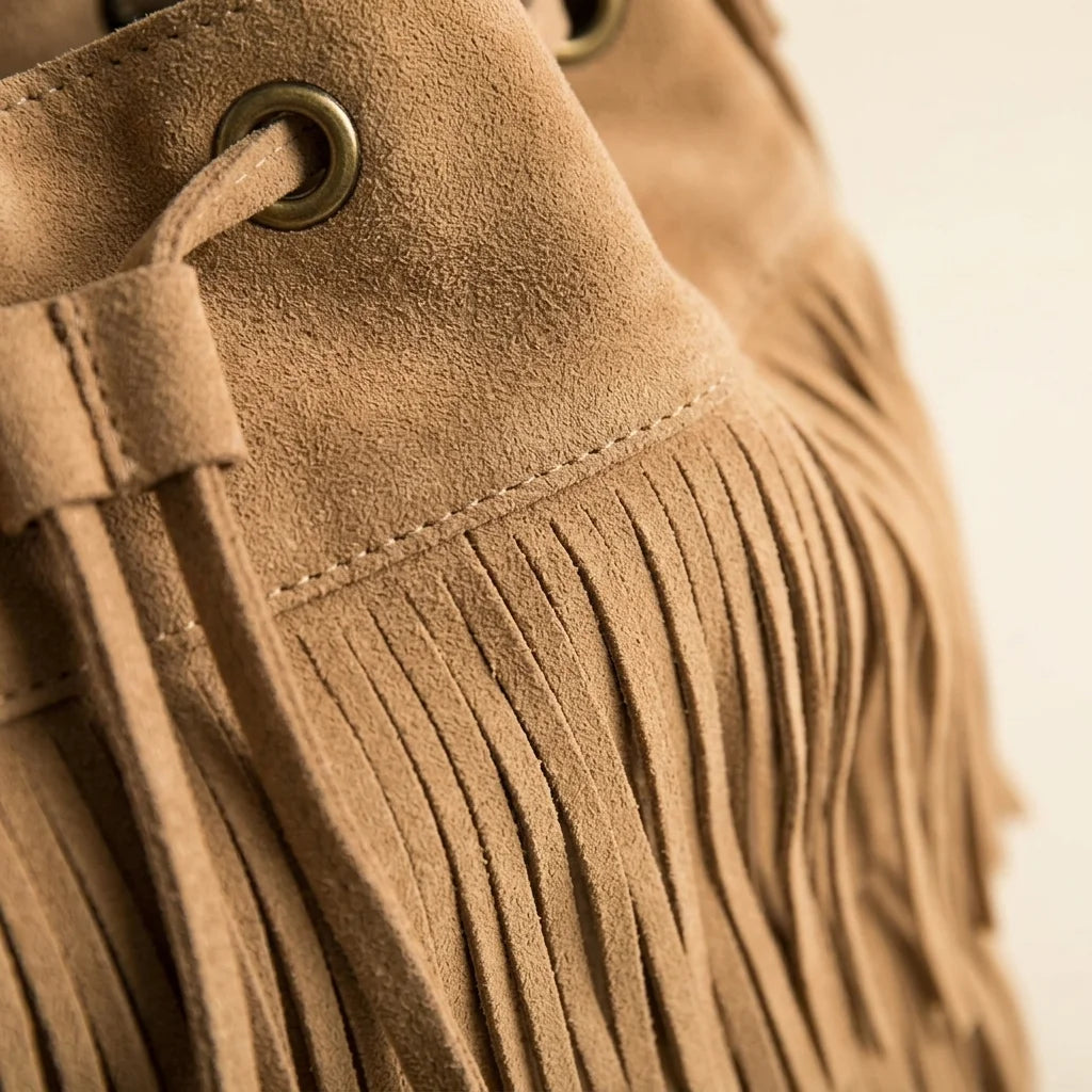 Close-up of fringe stitching and texture on Khaki camel fringe bucket bag