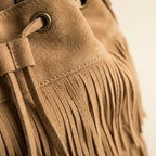 Close-up of fringe stitching and texture on Khaki camel fringe bucket bag