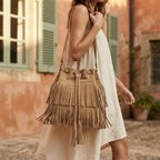 Woman wearing Khaki camel fringe bucket bag with swaying fringe