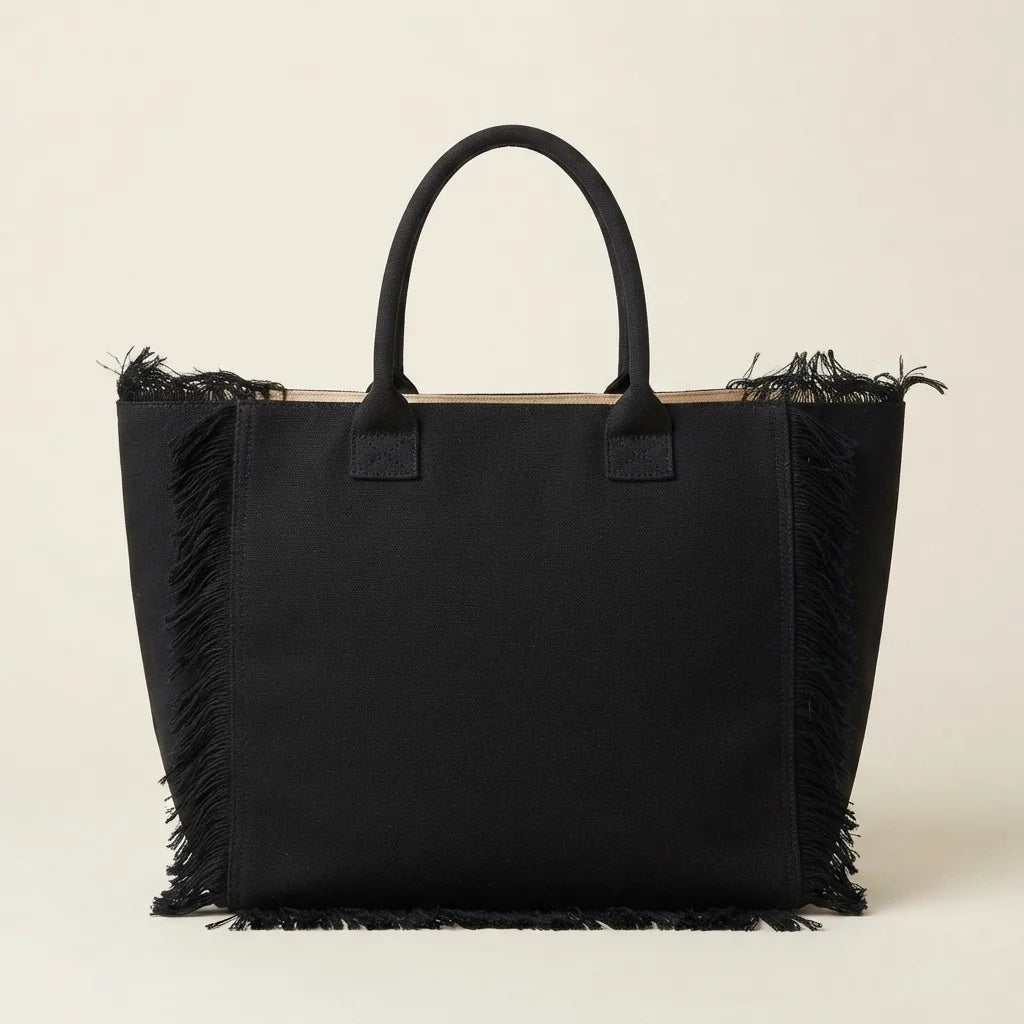 Back panel of Black canvas fringe tote bag with strap attachments