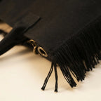 Close-up of fringe stitching and texture on Black canvas fringe tote bag