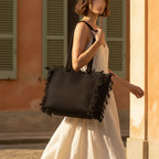 Woman wearing Black canvas fringe tote bag with swaying fringe