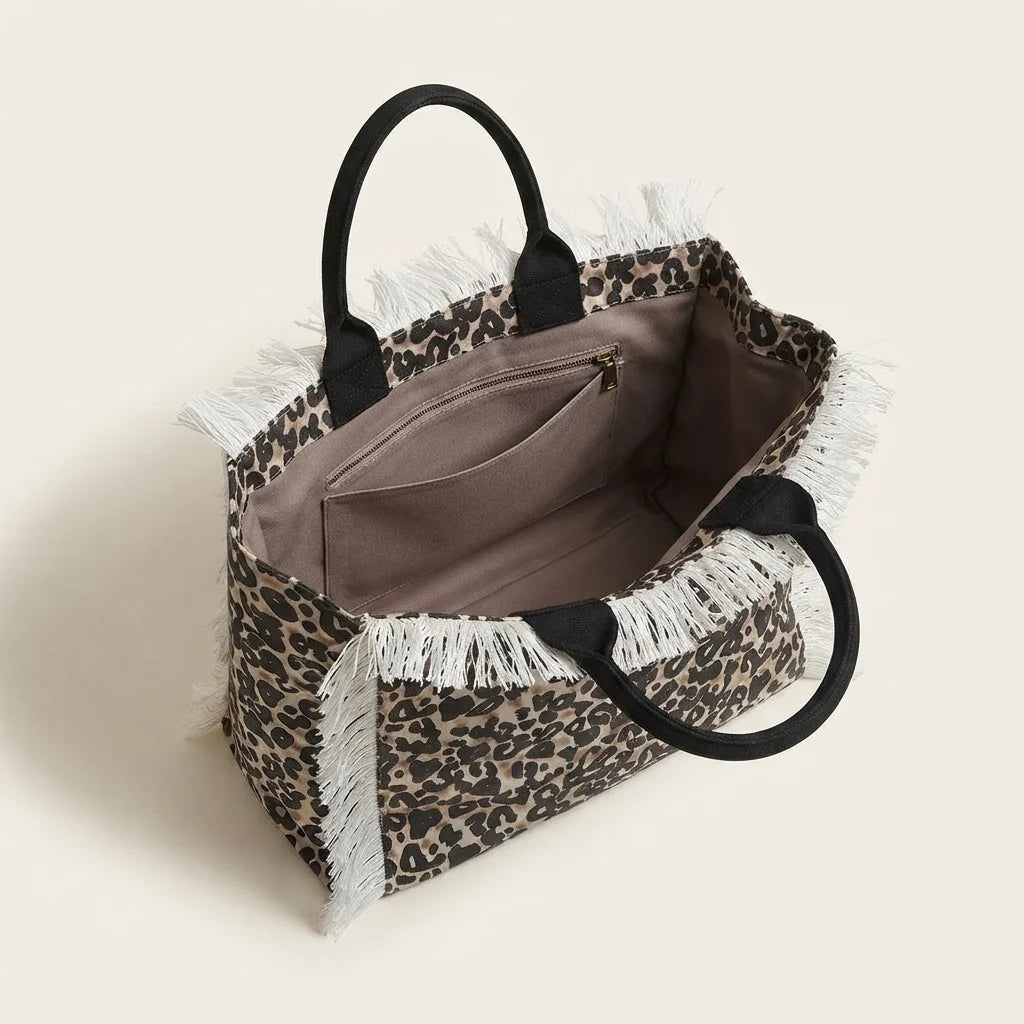 Interior lining and pockets of Leopard canvas fringe tote bag