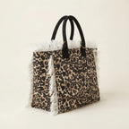 Leopard canvas fringe tote bag, three-quarter angle showing side depth