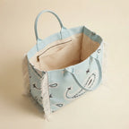 Interior lining and pockets of Light Blue canvas fringe tote bag