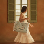Woman wearing Light Blue canvas fringe tote bag with swaying fringe