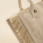 Close-up of fringe stitching and texture on White canvas fringe tote bag