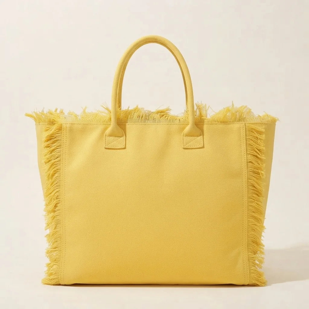Back panel of Yellow canvas fringe tote bag with strap attachments