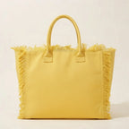 Back panel of Yellow canvas fringe tote bag with strap attachments