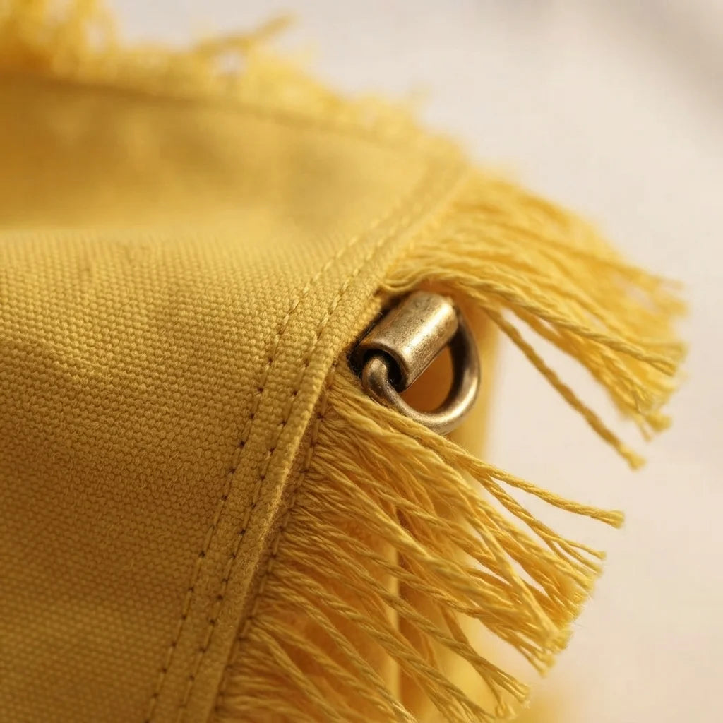Close-up of fringe stitching and texture on Yellow canvas fringe tote bag