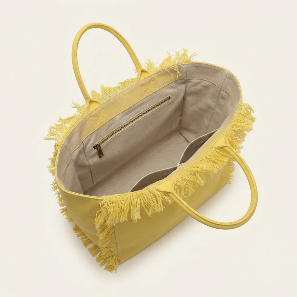Interior lining and pockets of Yellow canvas fringe tote bag