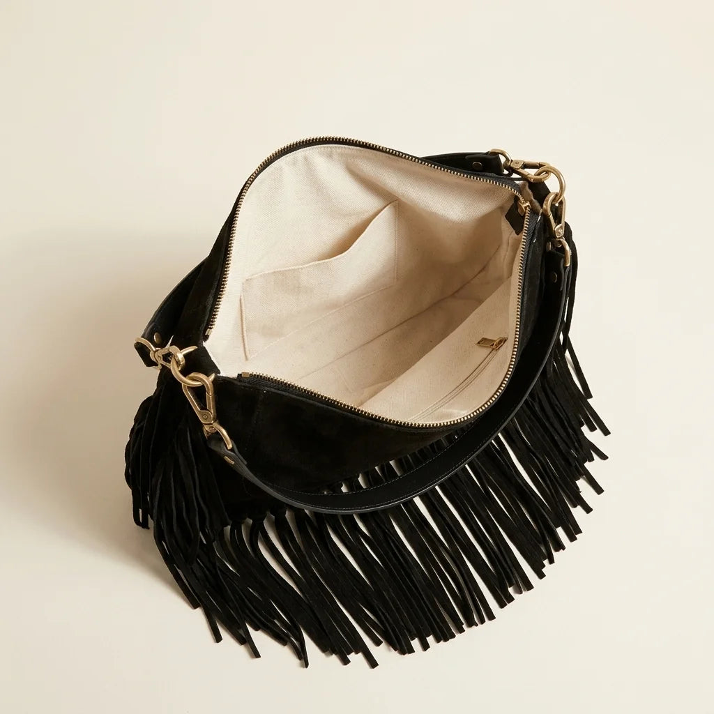 Interior lining and pockets of Black cowhide bag with fringe