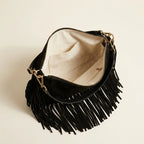 Interior lining and pockets of Black cowhide bag with fringe