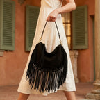 Woman wearing Black cowhide bag with fringe with swaying fringe