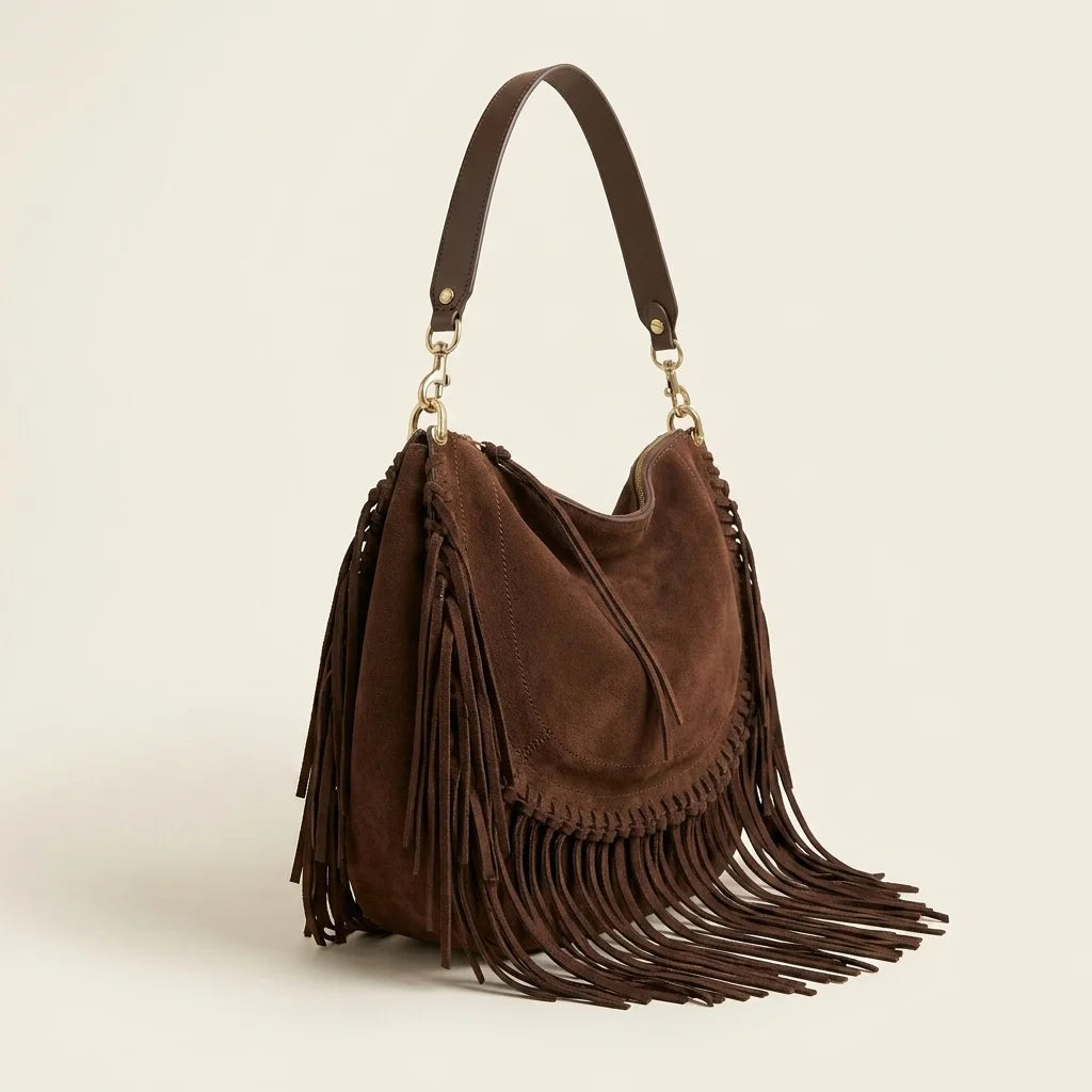 Coffee cowhide bag with fringe, three-quarter angle showing side depth