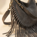 Close-up of fringe stitching and texture on Grey cowhide bag with fringe